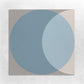an 8x8 cement tile with a circle graphic in the colors of blue, beige and grey