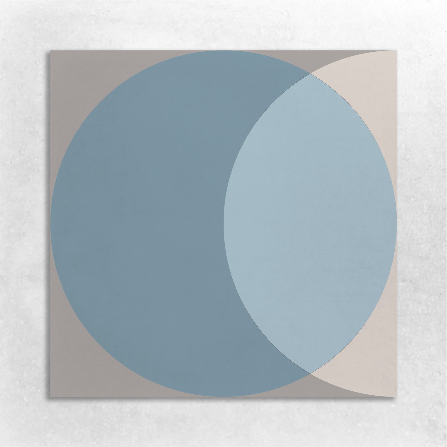 an 8x8 cement tile with a circle graphic in the colors of blue, beige and grey