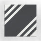 a square black tile bordered with black and white stripes