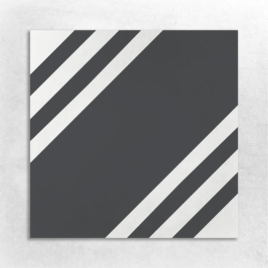a square black tile bordered with black and white stripes